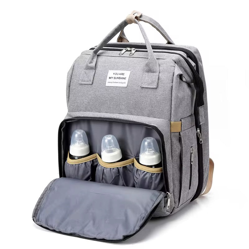 Pack Paseo Seguro: Mochila Maternal (Cuna Integrada) + Calentador USB de Regalo